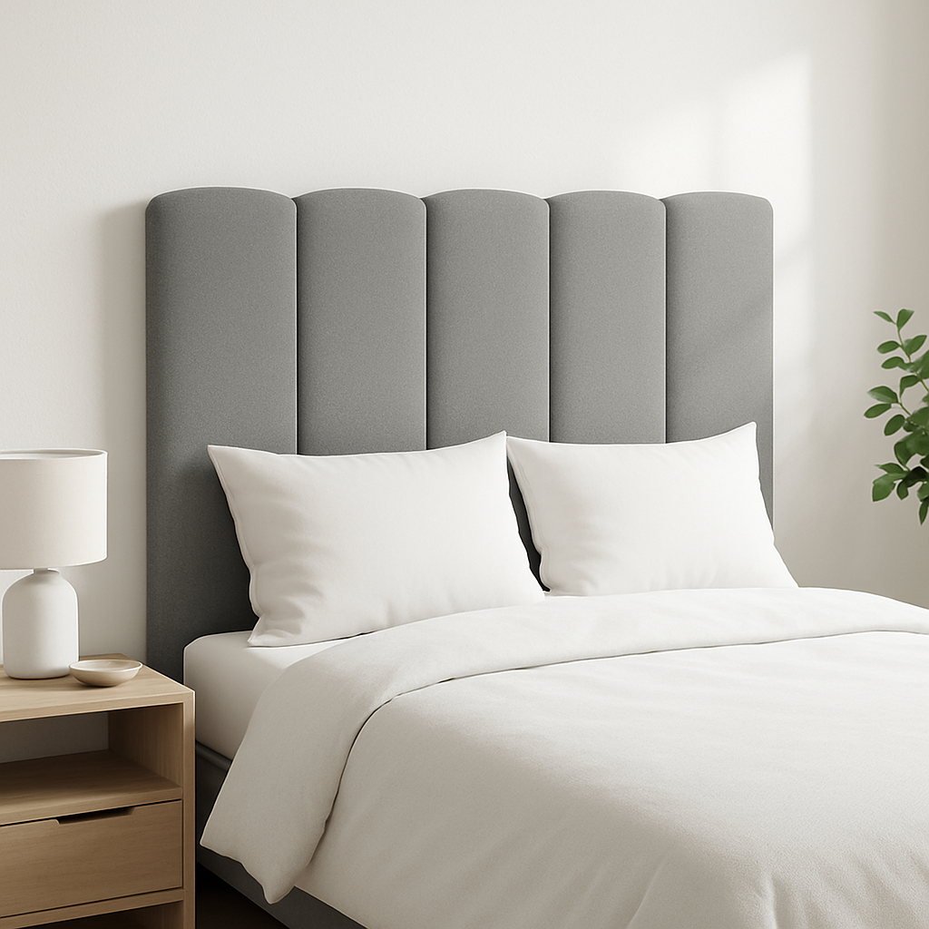 A gray Duna headboard by Morfeo in a bright bedroom with white bedding.