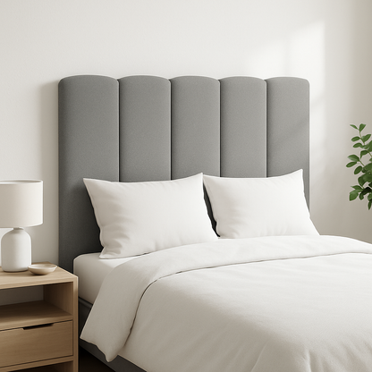 A gray Duna headboard by Morfeo in a bright bedroom with white bedding.