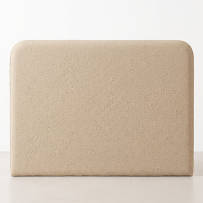Cabecero tapizado Saona beige de Morfeo con bordes redondeados en tejido bouclé, vista frontal sobre fondo blanco.
