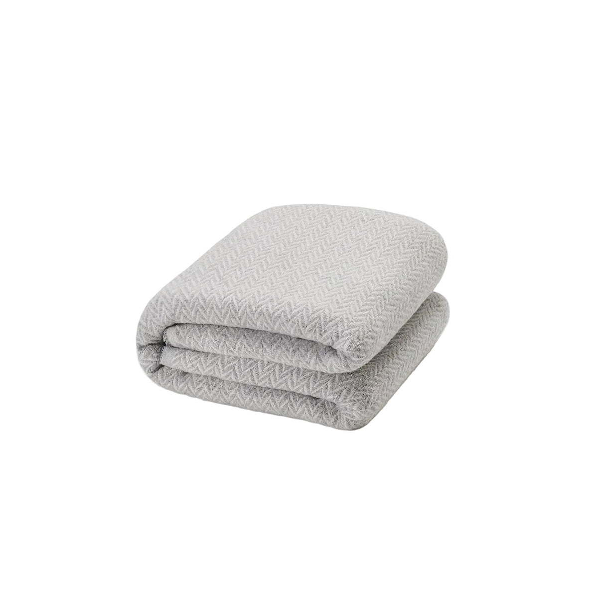 Mantita espiga gris de Morfeo doblada sobre fondo blanco, con tejido en espiga gris y blanco.